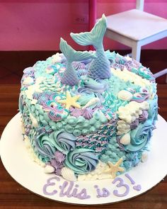 there is a cake decorated with blue and purple icing