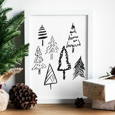 some pine cones are sitting on a table next to a christmas tree and present boxes