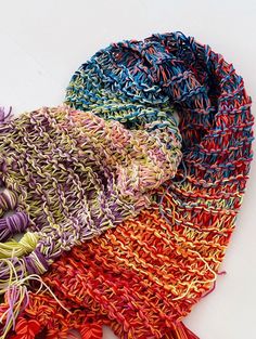 multicolored knitted scarf laying on top of each other