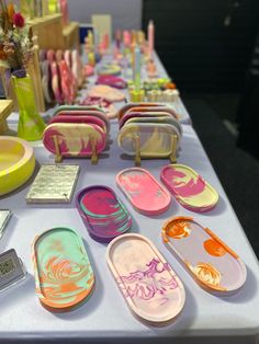 a table topped with lots of different colored plates