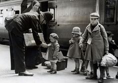 an old black and white photo of people getting off a train with luggage in front of them