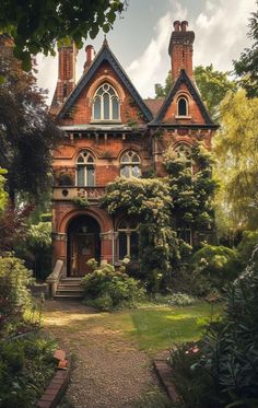 an old brick house surrounded by greenery and trees