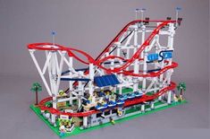 a toy roller coaster with people riding it