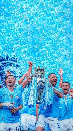 the manchester city team celebrate with the trophy