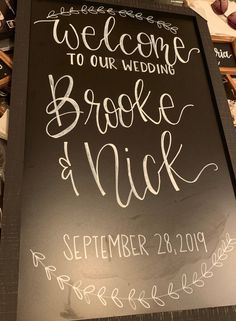 a chalkboard sign with the words welcome to our wedding brooke and nick written on it