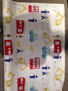 a child's crib sheet with construction vehicles on it, including trucks and planes