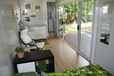 a living room filled with furniture and a sliding glass door that leads to a patio