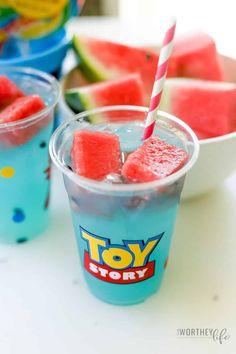 two cups filled with watermelon and ice cream on top of a white table