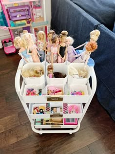 several barbie dolls are arranged on a cart