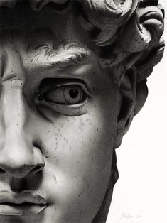 a black and white photo of a statue with an evil look on it's face