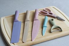 four different types of knives on a cutting board