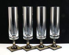 four glasses sitting on top of each other