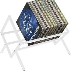 a white shelf with various colored records on it and an upside down magazine rack in the middle