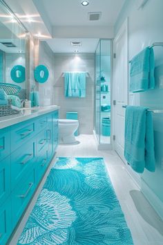 a bathroom with blue rugs on the floor