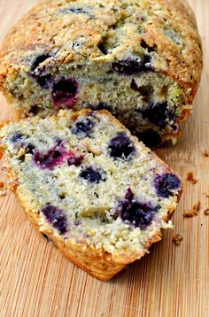 a blueberry muffin cut in half on a cutting board