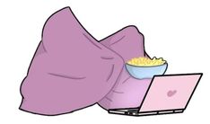 an image of a person laying on their stomach with a bowl of popcorn and laptop