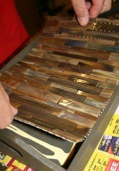 a person cutting wood with a knife on top of some sort of board that is being cut into pieces