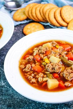 a bowl of soup and crackers on a table