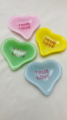 three heart shaped dishes with true love written on them