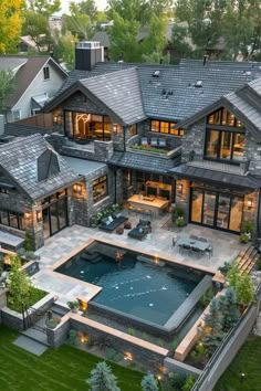 an aerial view of a large house with a pool and hot tub in the yard