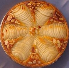 a pie with sliced apples and almonds on top