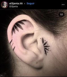 an ear tattoo with black leaves on it