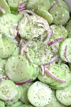 cucumbers and onions are mixed together in a salad with seasoning on top