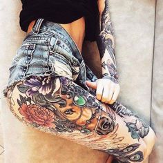 a woman with tattoos on her leg