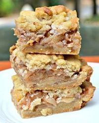 a stack of dessert bars sitting on top of a white plate