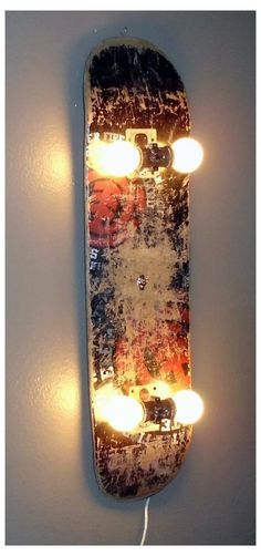 a skateboard with lights attached to it on the wall next to a light bulb