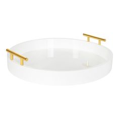 a white bowl with two gold handles on the top and bottom, in front of a white background