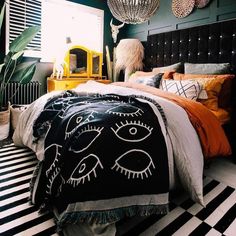 a bedroom with black and white striped flooring, green walls and an eyeball chandelier hanging from the ceiling