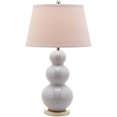 a table lamp with a white shade on the base and a light bulb in front of it