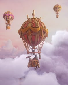 two hot air balloons in the sky with clouds around them and some people flying above