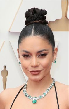 an image of a woman wearing jewelry on the oscars red carpet with her hair in a bun