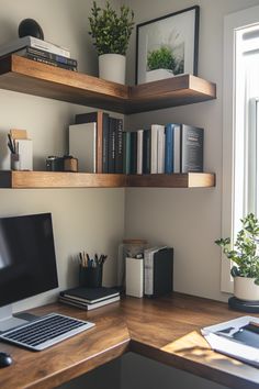 a laptop computer sitting on top of a wooden desk