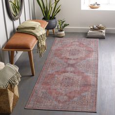 a large rug in the corner of a room next to a chair and potted plants