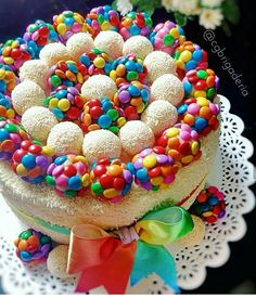 the cake is decorated with candy and sprinkles on it's top