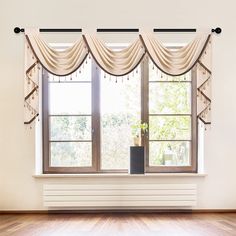 an empty room with a large window and wooden floors