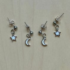 This is sold as a set. Earring set includes 1 pair of moon earrings and 1 pair of star earrings. Celestial White Sterling Silver Earrings, White Sterling Silver Celestial Earrings, White Sterling Silver Earrings With Star Charm, White Star-shaped Earrings As Gift, Dainty White Earrings With Star Charm, White Dangle Cartilage Earrings, White Celestial Star Earrings, Celestial White Star Earrings, White Star-shaped Nickel-free Earrings