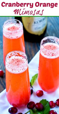 two glasses filled with cranberry orange mimos on top of a white napkin