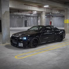 a black car parked in a parking garage