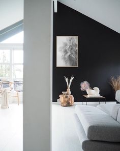 a living room filled with furniture and black walls