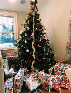 a decorated christmas tree with presents under it