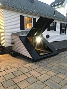 an upside down house in the middle of a driveway