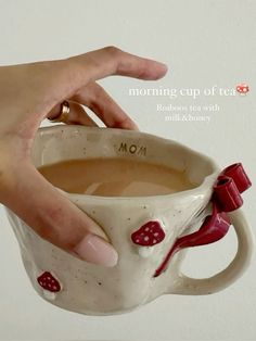 a person holding a coffee mug in their left hand with the words morning cup of tea on it