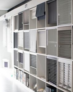 a book shelf filled with lots of books on top of white shelving unit units