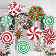 christmas decorations hanging from the ceiling with candy canes and wreaths in front of them