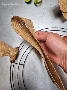 a person holding a straw hat on top of a table