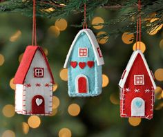 three felt houses hanging from a christmas tree